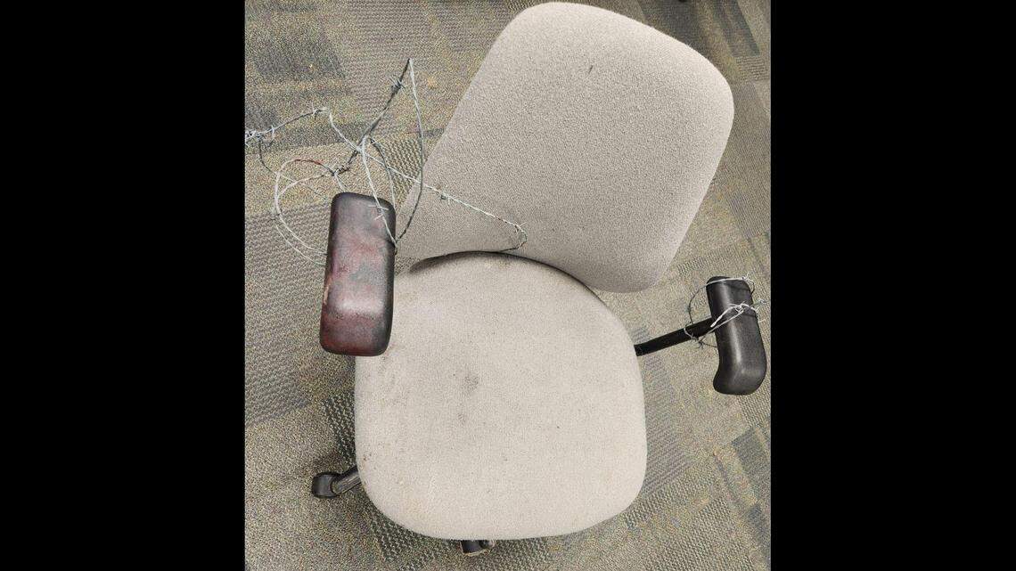 The victim hands and feet were tied to this chair with barb wire, investigators say, Three people have been charged.