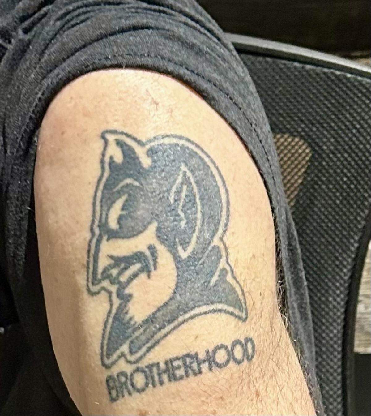 Former Duke basketball star Mike Gminski displays a tattoo on his shoulder on Dec. 17, 2024, that celebrates his career with the Blue Devils and the brotherhood he has with others in the basketball program. He has numerous other tattoos as well, all emblematic of his Christian faith.
