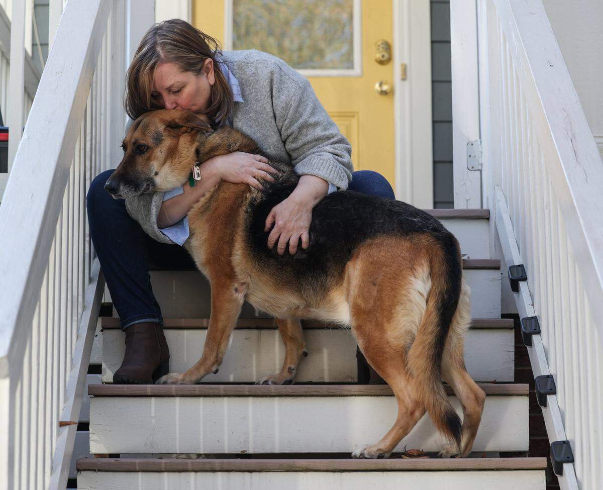 Gwyneth Brown hugs and kisses her dog, Sadie, who has been a great comfort since Brown’s son, Laird Ramirez, a 17-year-old, who died last July after taking a pressed pill that disguised fentanyl.