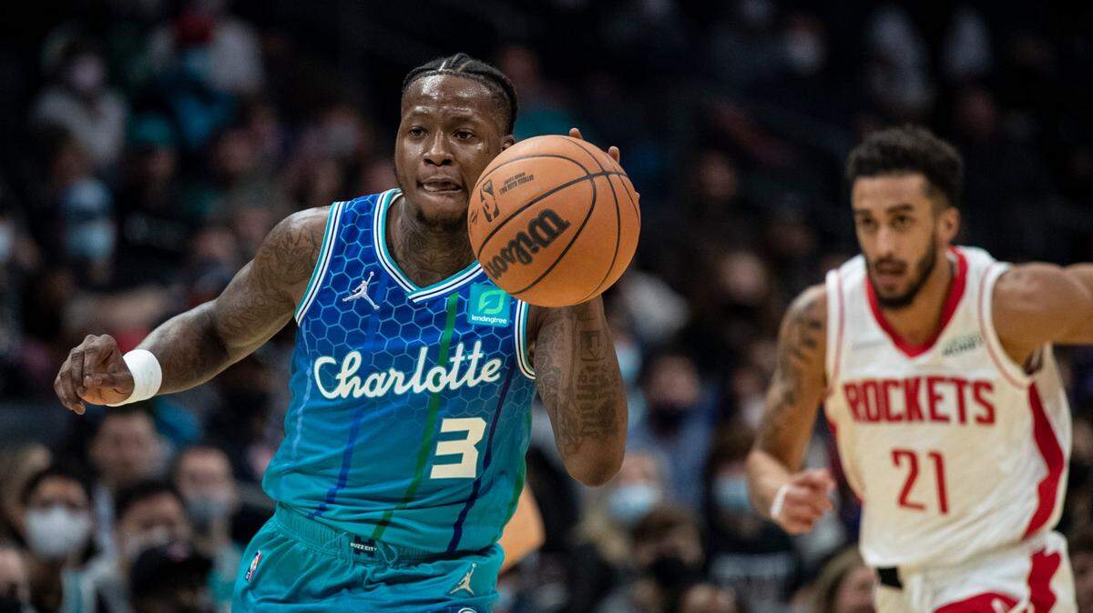 Charlotte Hornets guard Terry Rozier (3) drives the ball up court past Houston Rockets guard Trevelin Qeen (21) during the first half of an NBA basketball game Monday, Dec. 27, 2021, in Charlotte, N.C. (AP Photo/Matt Kelley)