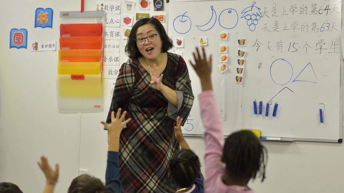 Teacher Yan Han helps students as she teaches a kindergarten class at East Voyager Academy in Charlotte.