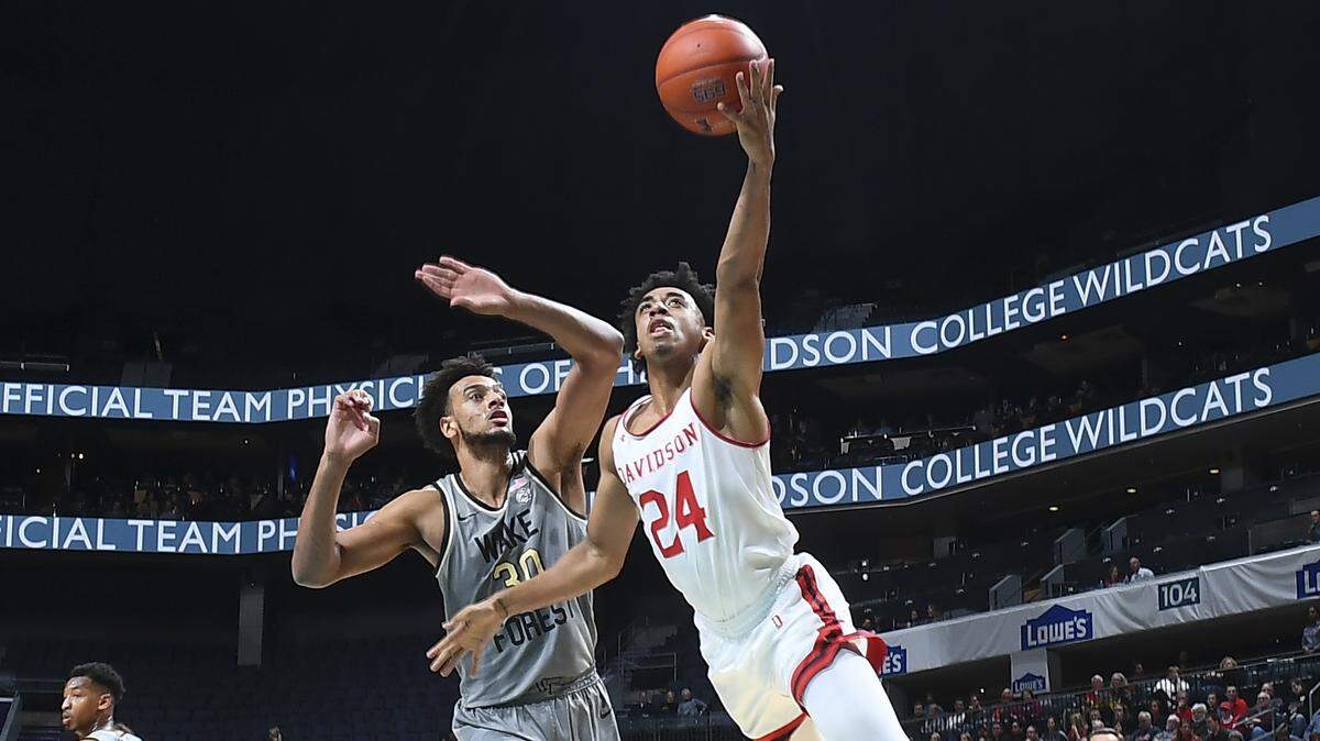 Davidson’s Carter Collins (24) goes to the basket against Wake Forest’s Olivier Starr (30).