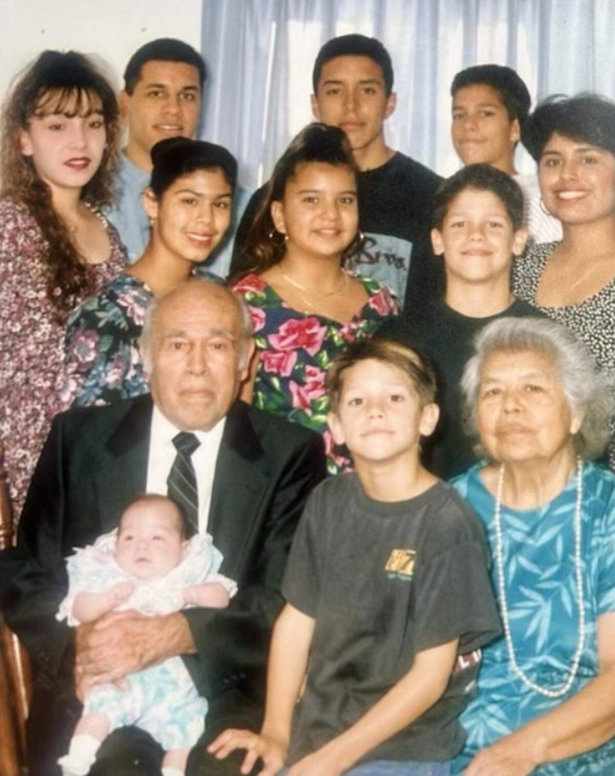 An undated photo of Panthers head coach Dave Canales (second row on right, wearing black shirt) and some of his extended family. His grandfather Miguel (seated, holding baby) came to the United States from Mexico as a child, later joining the military and then establishing a church where he became pastor. Lupe, his wife, is seated on bottom right and also immigrated from Mexico as a child.