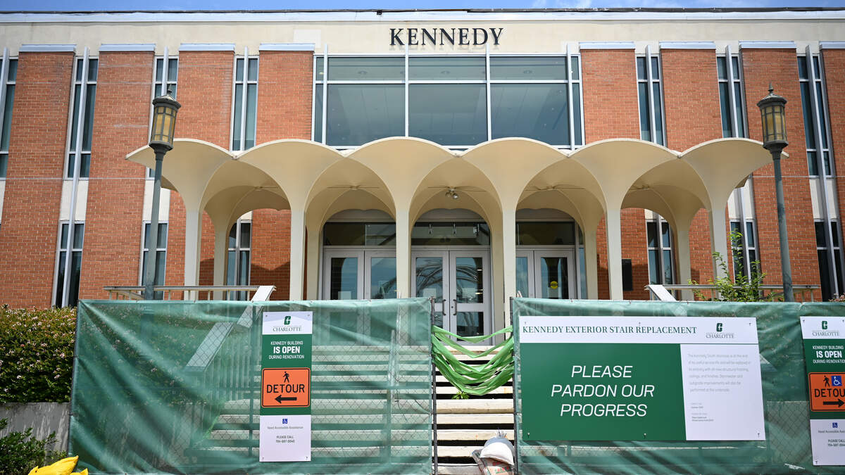 The Kennedy Building stands behind a construction barrier on UNC Charlotte’s campus on Thursday. UNC Charlotte will demolish the iconic Kennedy Building canopy due to drainage damage. University officials said the demolition is necessary and the structure cannot be rebuilt.