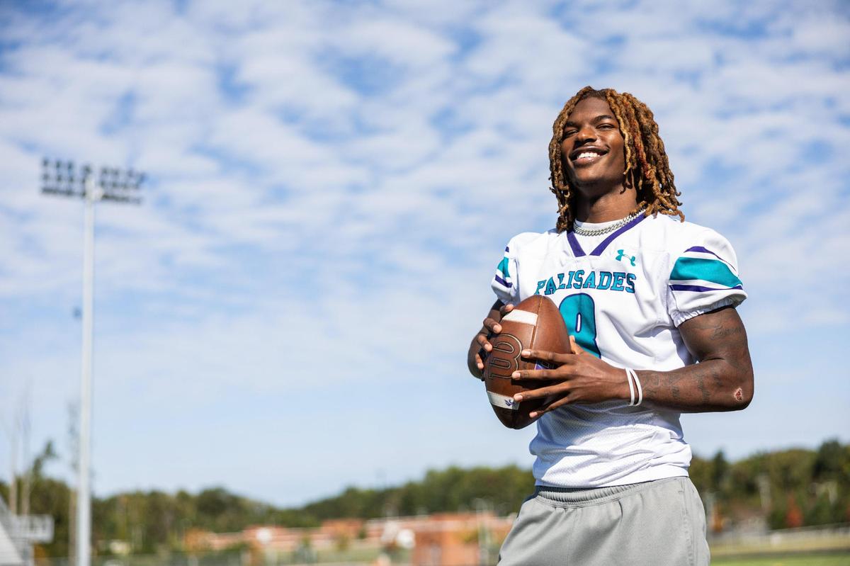 Palisades linebacker, Kendric Davis, passes a ball for.a portrait at Palisades High School in Charlotte, N.C. on Tuesday, October 15, 2024.