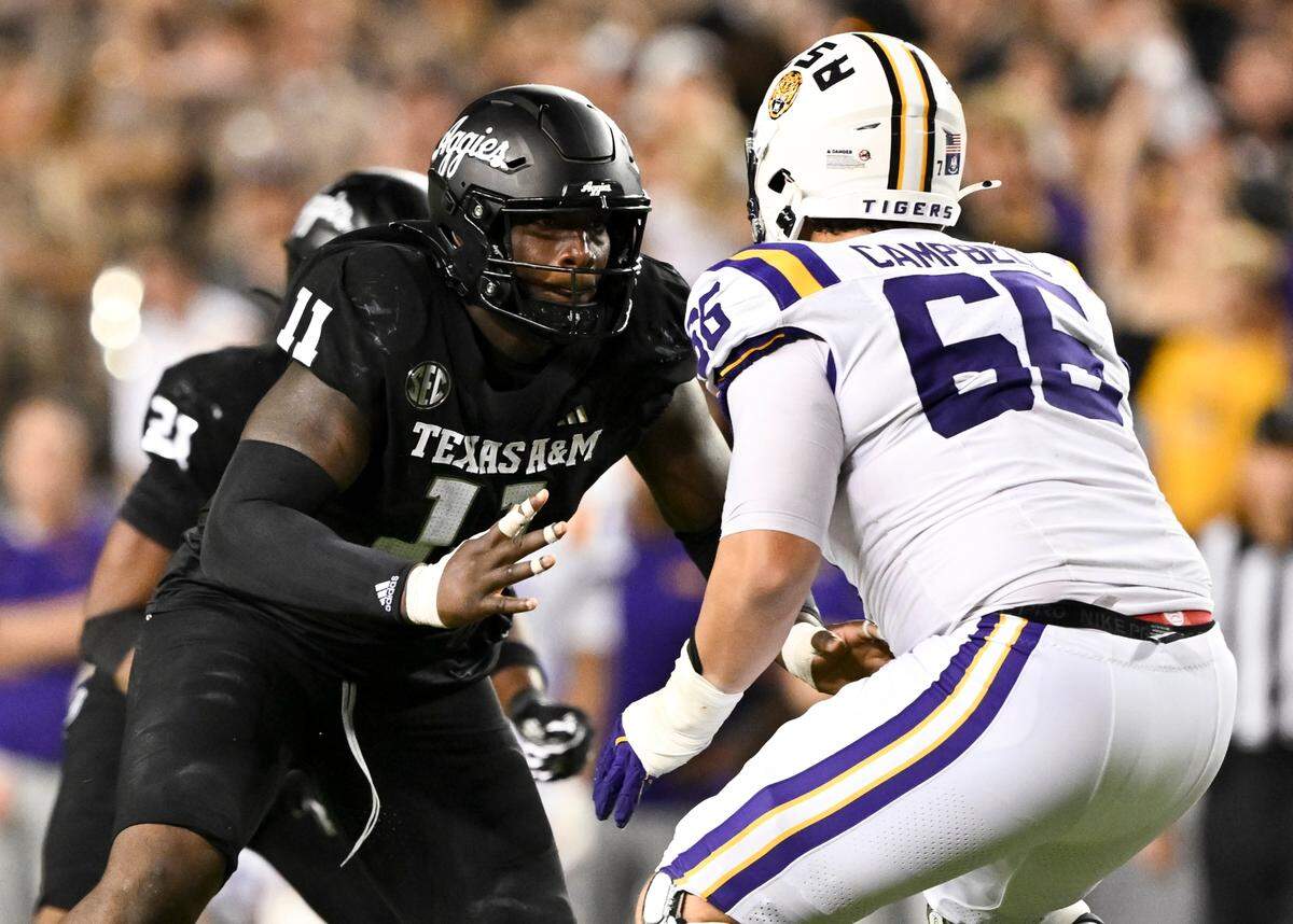 Texas A&M defensive lineman Nic Scourton (11) defends in coverage against LSU offensive tackle Will Campbell (66) during a game last season. Maria Lysaker-Imagn Images.