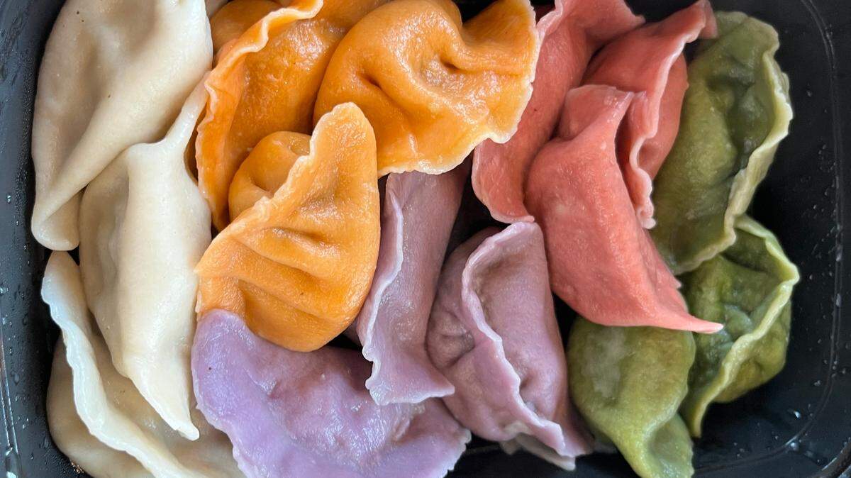 The colorful dumpling flight from Sun’s Kitchen comes with pork and Chive (white), beef and carrot (orange), chicken and mushroom (pink), veggie (green) and shrimp and chicken (violet).