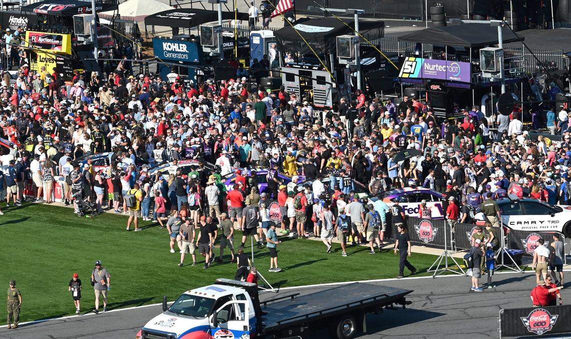 NASCAR fans gather around their favorite drivers cars along pit road at Charlotte Motor Speedway prior to the start of the Coca-Cola 600 on Sunday, May 29, 2022.
