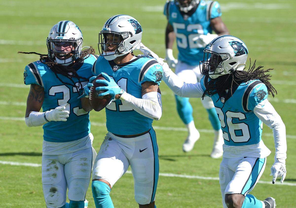 Carolina Panthers safety Jeremy Chinn, center, runs to the end zone with his teammates safety Tre Boston, left and cornerback Donte Jackson, right, following Chinn’s interception of a Chicago Bears pass during third quarter action at Bank of America Stadium in Charlotte, NC on Sunday, October 18, 2020. The Bears defeated the Panthers 23-16.