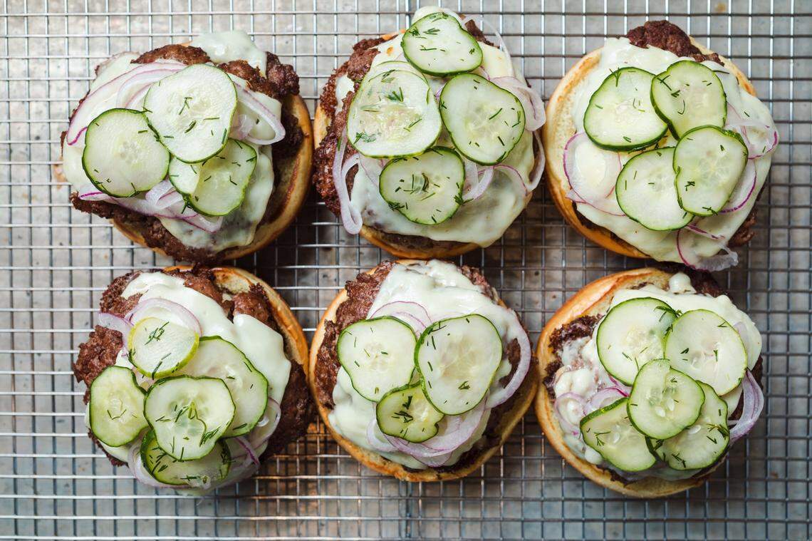 Harriet’s Hamburgers are topped with white American cheese from an artisanal creamery, house-made zesty pickles, razor ribboned red onions, and a sweet and tangy signature sauce.