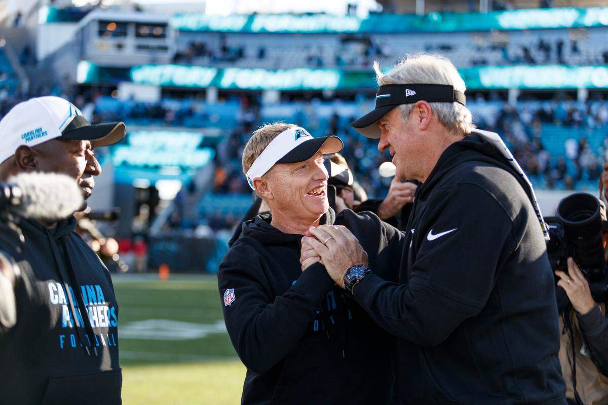 Jacksonville Jaguars head coach Doug Pederson and Carolina Panthers interim head coach Chris Tabor shake hands after the game at EverBank Stadium.