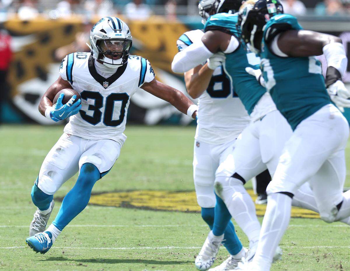 Carolina Panthers running back Chuba Hubbard, left, looks to break back to the inside for yardage against the Jacksonville Jaguars during action on Sunday, September 7, 2025 at Everbank Stadium in Jacksonville, Florida.
