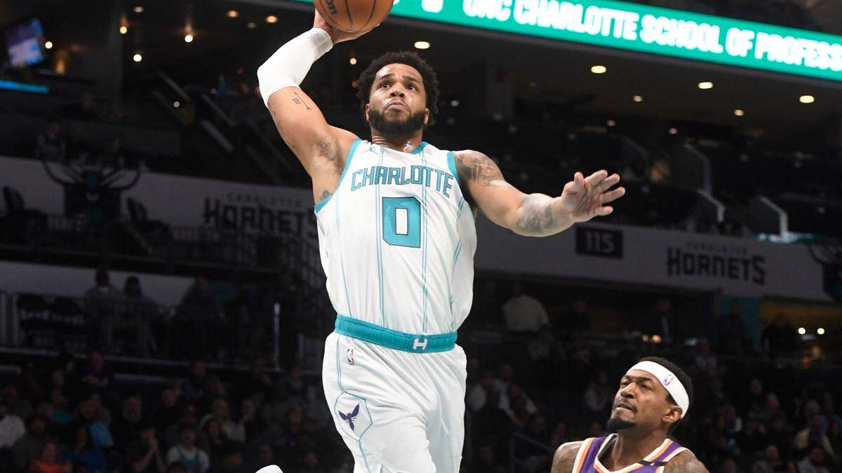 Jan 7, 2025; Charlotte, North Carolina, USA; Charlotte Hornets forward Miles Bridges (0) dunks during the first half again not the Phoenix Suns at the Spectrum Center.