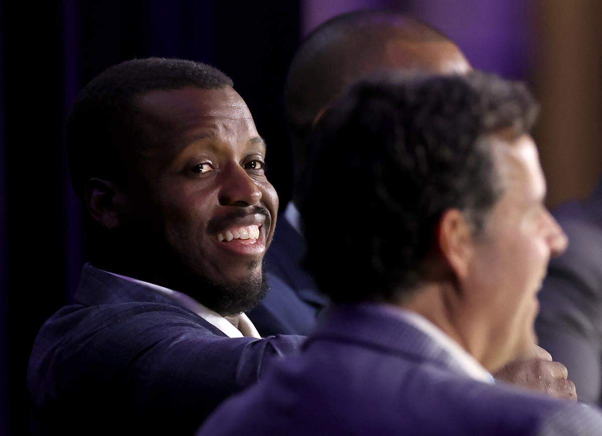 Former Carolina Panthers running back Jonathan Stewart glances over at emcee Jim Szoke, right, during the Charlotte Touchdown Club’s Carolina Panthers Kickoff Luncheon on Thursday, August 29, 2024. WBT Radio Sports Director Jim Szoke emceed a discussion with former running back Jonathan Stewart, Rucker and former defensive end Al Wallace.