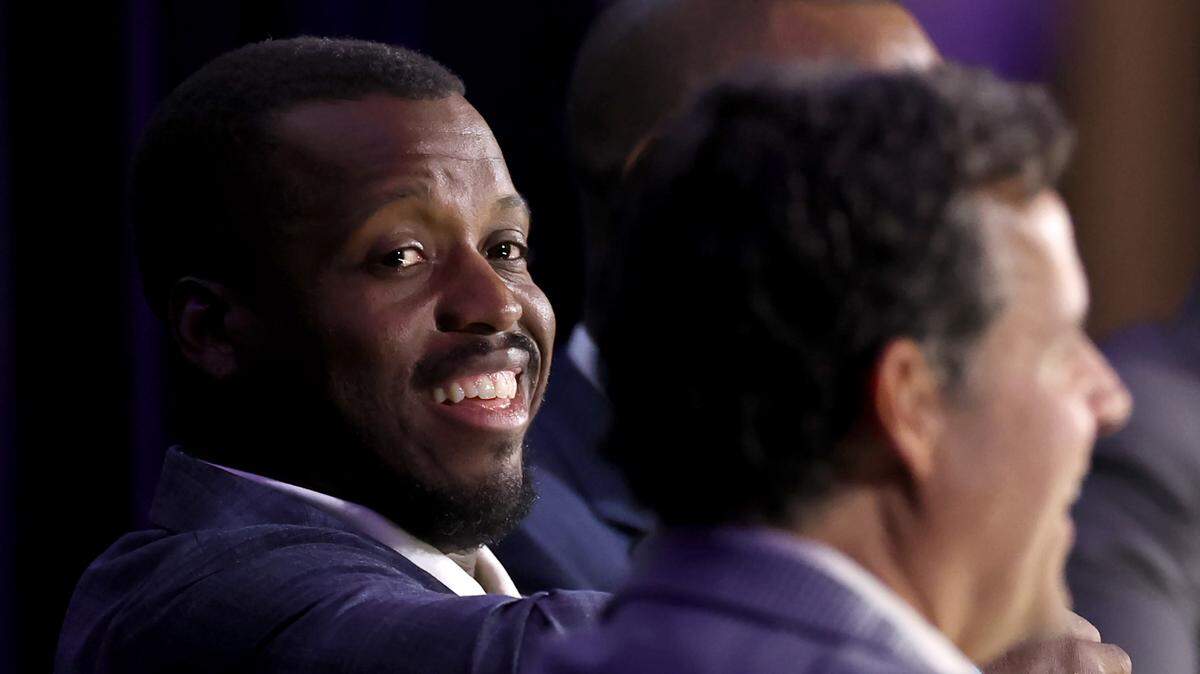 Former Carolina Panthers running back Jonathan Stewart glances over at emcee Jim Szoke, right, during the Charlotte Touchdown Club’s Carolina Panthers Kickoff Luncheon on Thursday, August 29, 2024. WBT Radio Sports Director Jim Szoke emceed a discussion with former running back Jonathan Stewart, Rucker and former defensive end Al Wallace.
