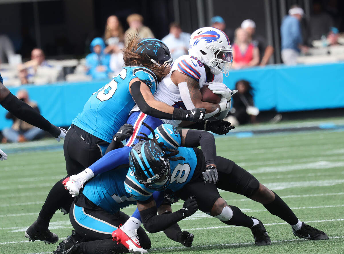 Buffalo Bills' Ray Davis is tackled by Carolina Panthers' Christian Rozeboom (56), Nic Scourton (11) and Jaycee Horn (8) during Sunday’s game at Bank of America Stadium.