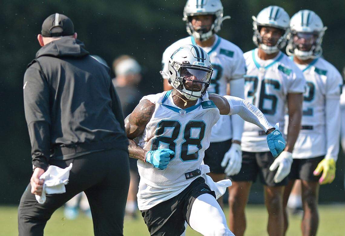 Carolina Panthers wide receiver Terrace Marshall Jr. cuts inside as he rushes around offensive coordinator Joe Brady, left, during practice at Wofford College in Spartanburg, SC., on July 29.