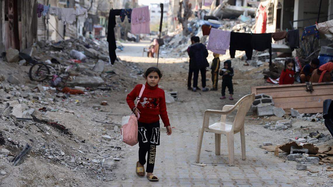A girl walks on a street in Gaza City on Feb. 27, 2024 surrounded by destroyed buildings. The Palestinian death toll in the Gaza Strip has surpassed 30,000, the Hamas-run Health Ministry said Thursday.