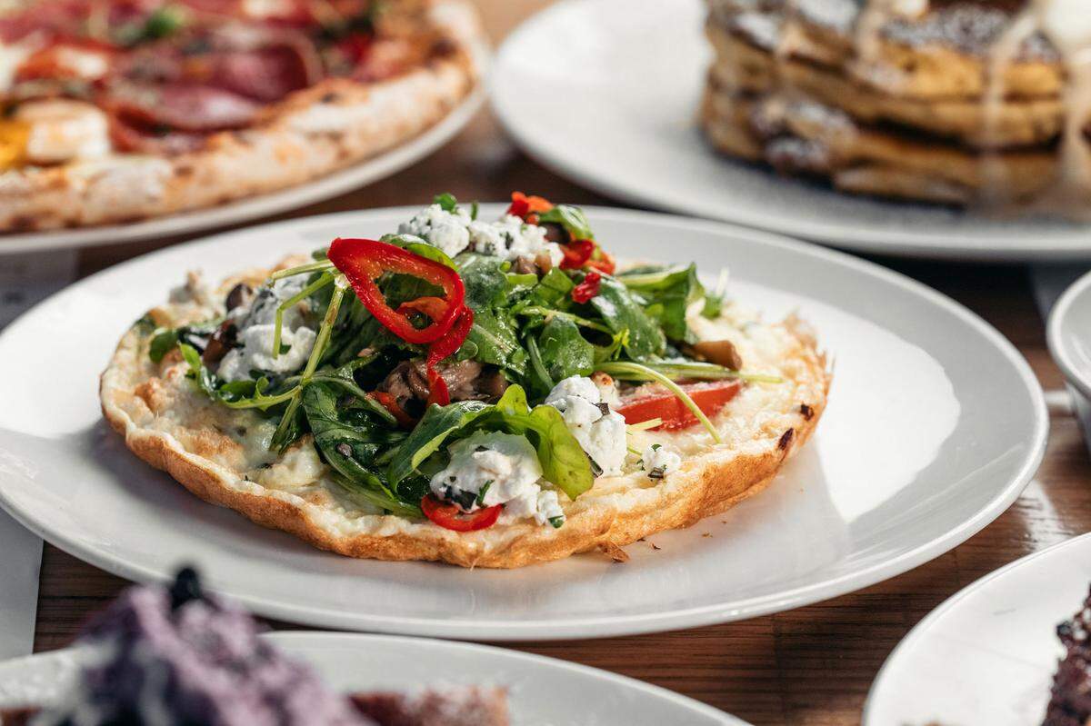 Egg white and goat cheese frittatta from Sixty Vines made with wild mushrooms, spinach, herbed tomatoes, goat cheese, pecorino and arugula.