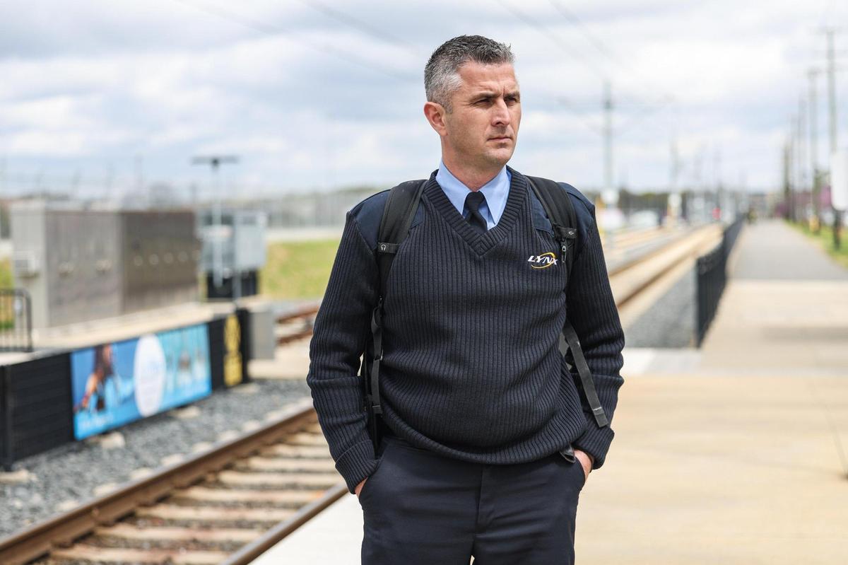 Light rail operator Michael Wilder waits at the Parkwood Station for the Blue Line of the LYNX light rail so he can begin his shift as light rail operator.
