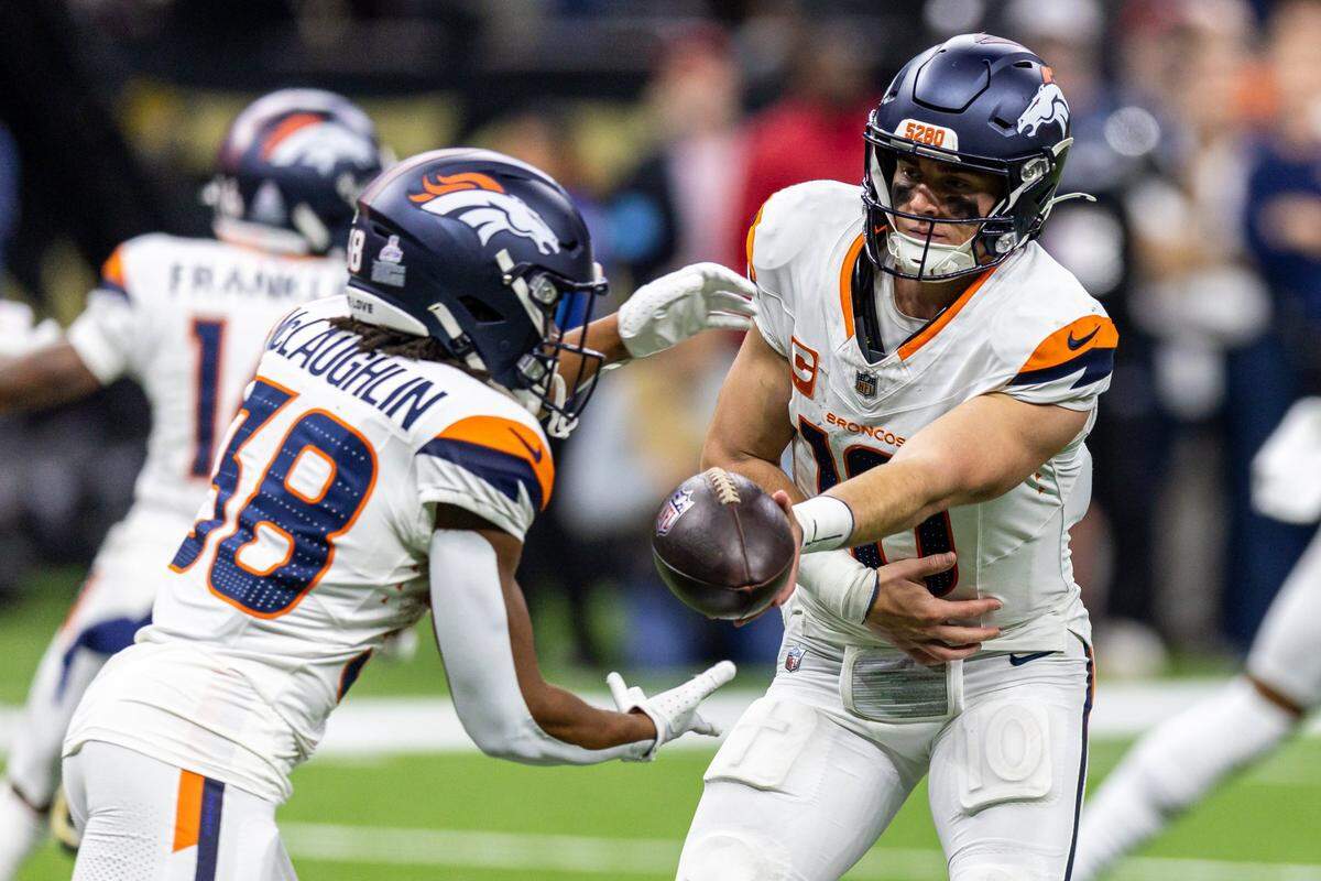 Oct 17, 2024; New Orleans, Louisiana, USA;  Denver Broncos quarterback Bo Nix (10) hands off to running back Jaleel McLaughlin (38) against the New Orleans Saints during the second half at Caesars Superdome. Mandatory Credit: Stephen Lew-Imagn Images