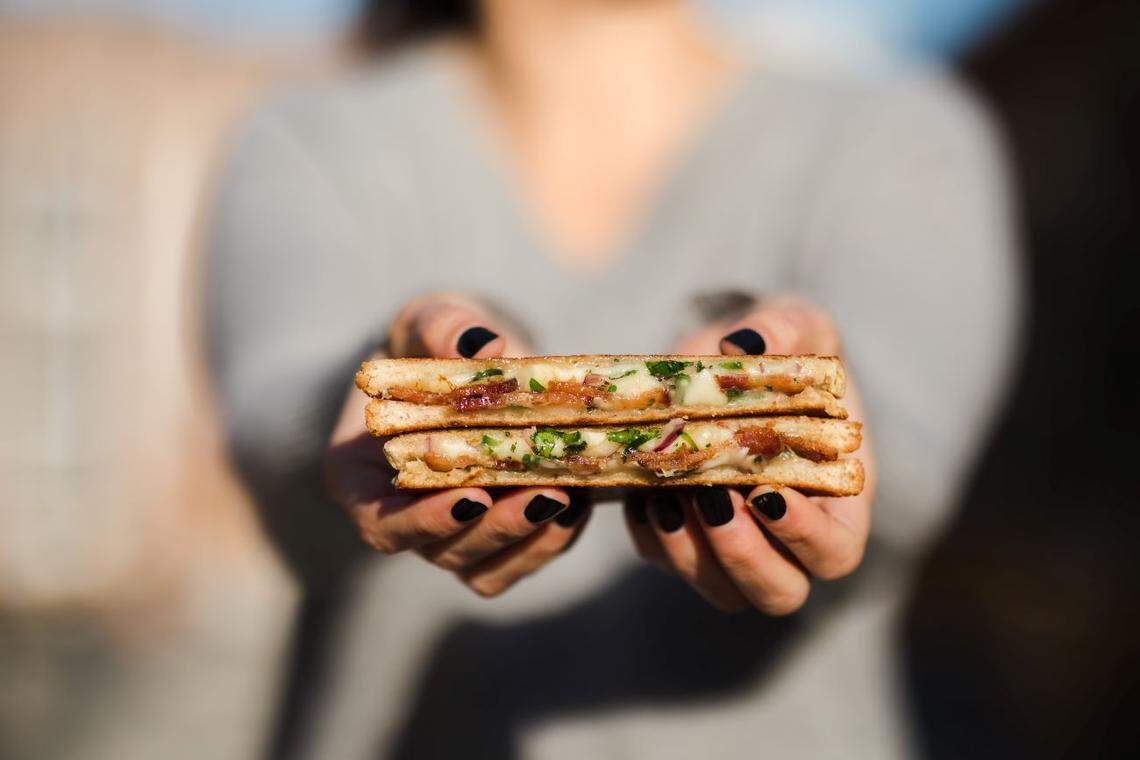 The Bacon Jalapeno grilled cheese at Papi Queso is prepared with three cheeses and strips of crispy bacon.