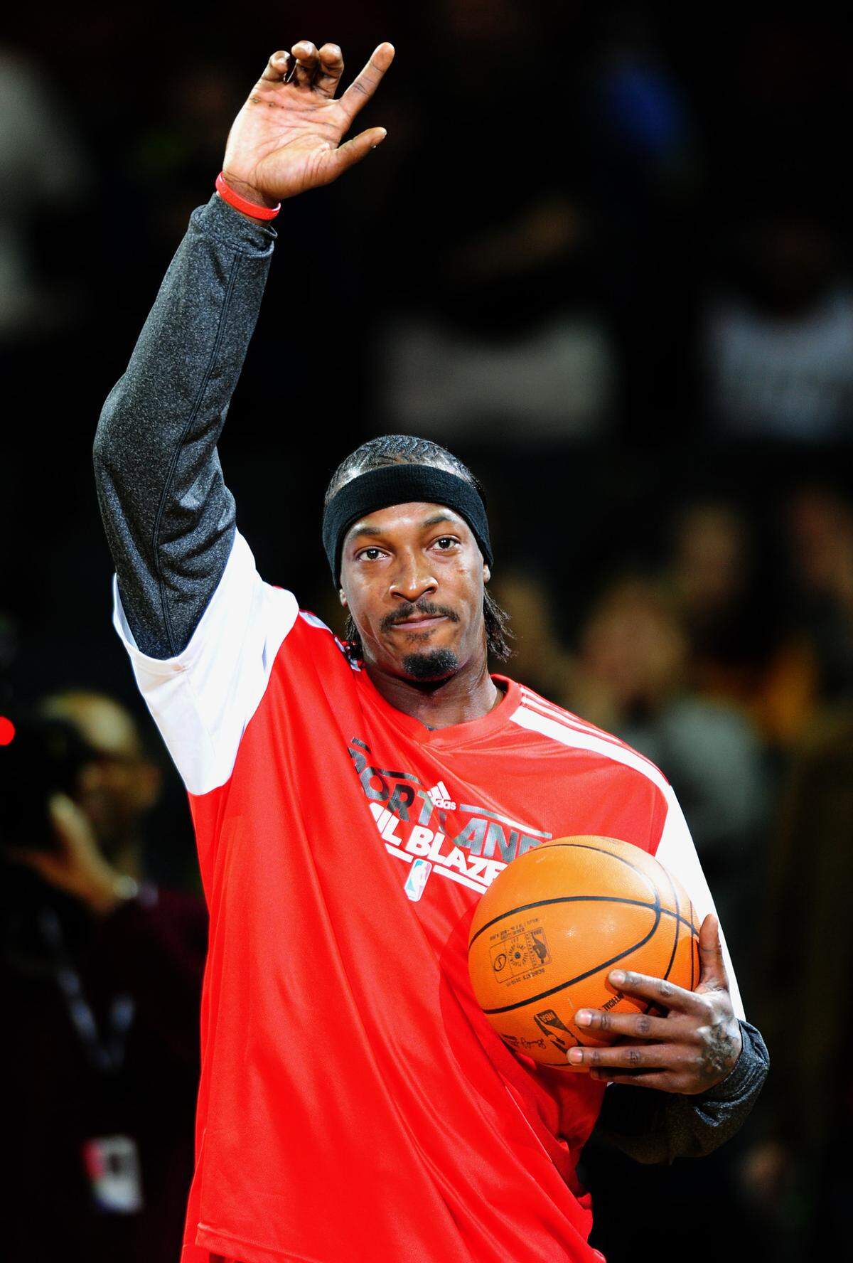 Former Charlotte Bobcats All-Star Gerald Wallace waves to the crowd as a member of the Portland Trail Blazers.