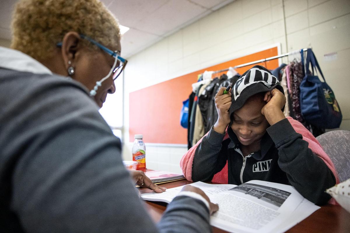 Camille Stephens, left, helps Mekayla Rodgers, 18, at the Juvenile Court Intervention Program in Charlotte, N.C., on Tuesday, March 30, 2022. Rodgers, 18, has been in juvenile detention twice. She has a 6-month-old son and says she wants learn “to do hair” and possibly go into the military.