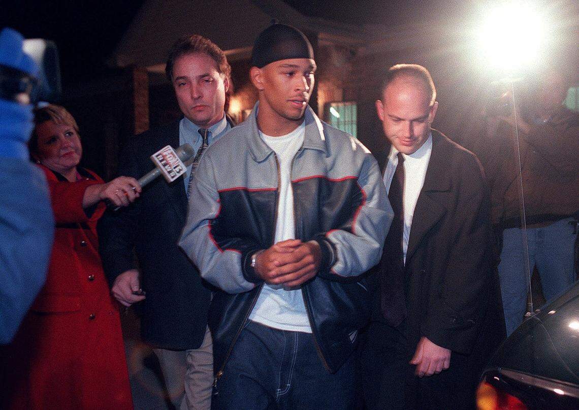 Carolina Panthers wide receiver Rae Carruth is escorted to a waiting car in Jackson, Tenn., after being questioned following his arrest by FBI agents on Dec. 15, 1999. Carruth had been a fugitive since being charged with first-degree murder following the death of Cherica Adams.