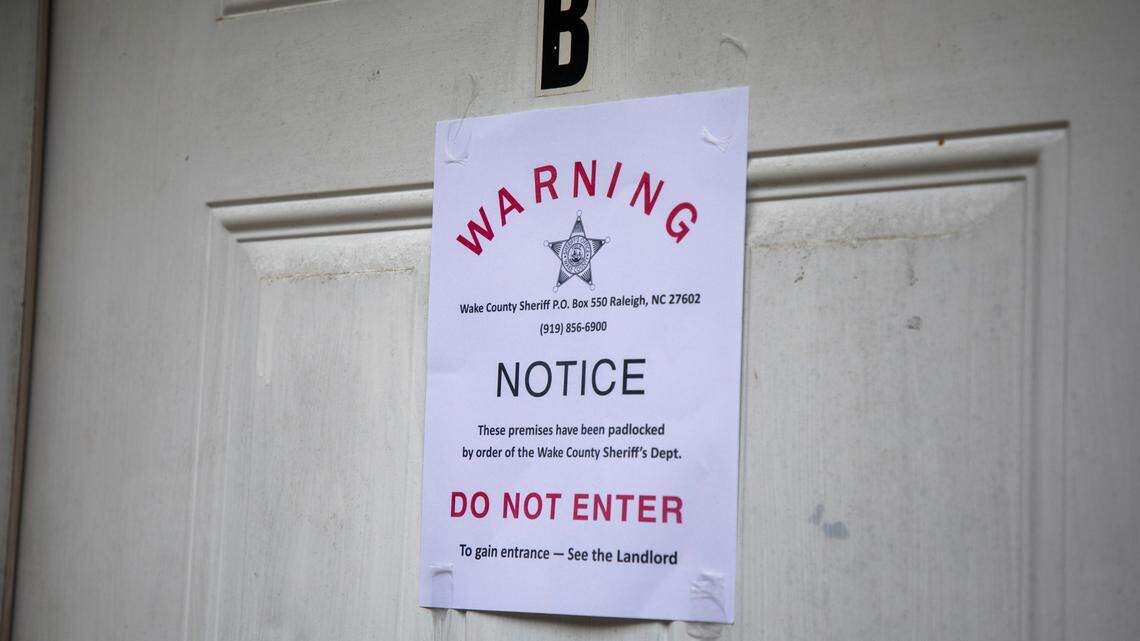 A padlock notice is taped to the door of a Raleigh apartment. File photo from Aug. 19, 2020.