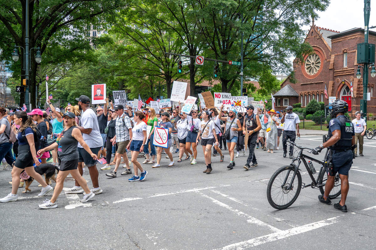 Charlotte residents march through the streets for the No Kings march and rally in Charlotte Saturday, June 14, 2025.
