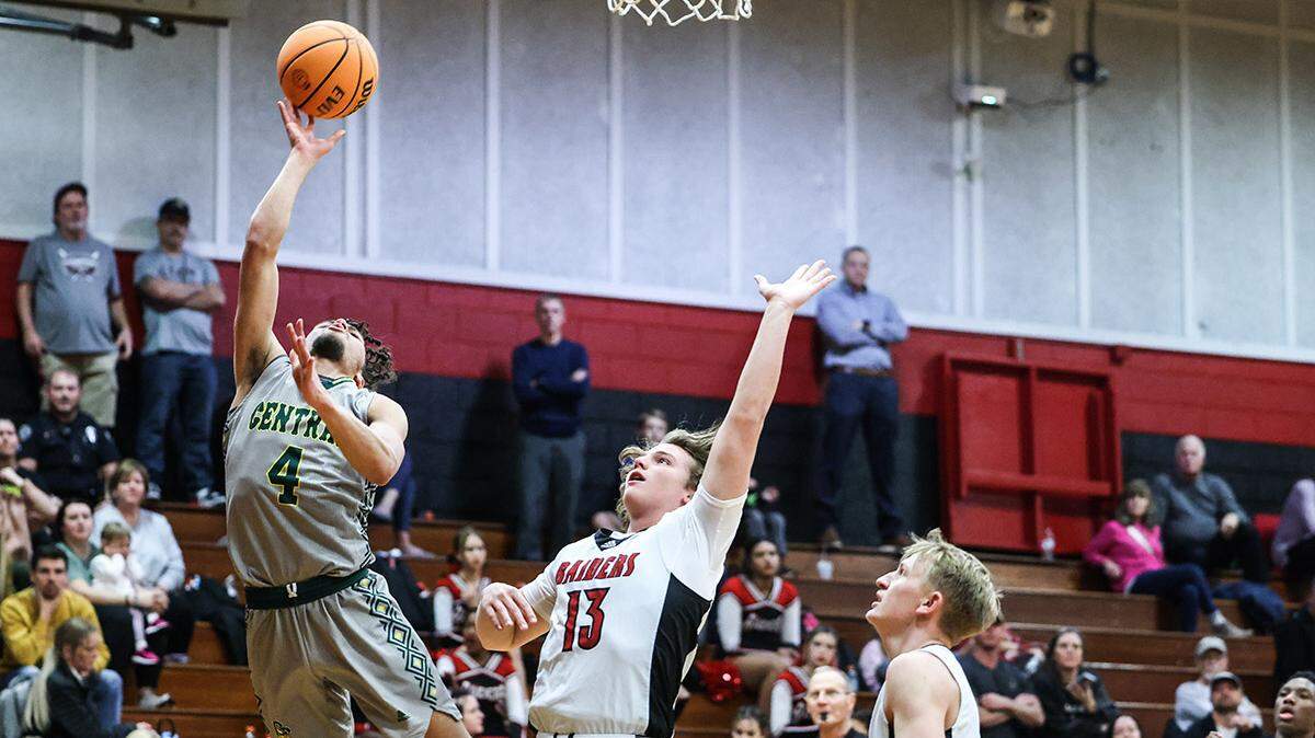 Central Cabarrus Vikings Chase Daniel, left, shoots past South Rowan Raiders Brooks Overcash at South Rowan High School in China Grove, N.C., on Tuesday, January 23, 2024.
