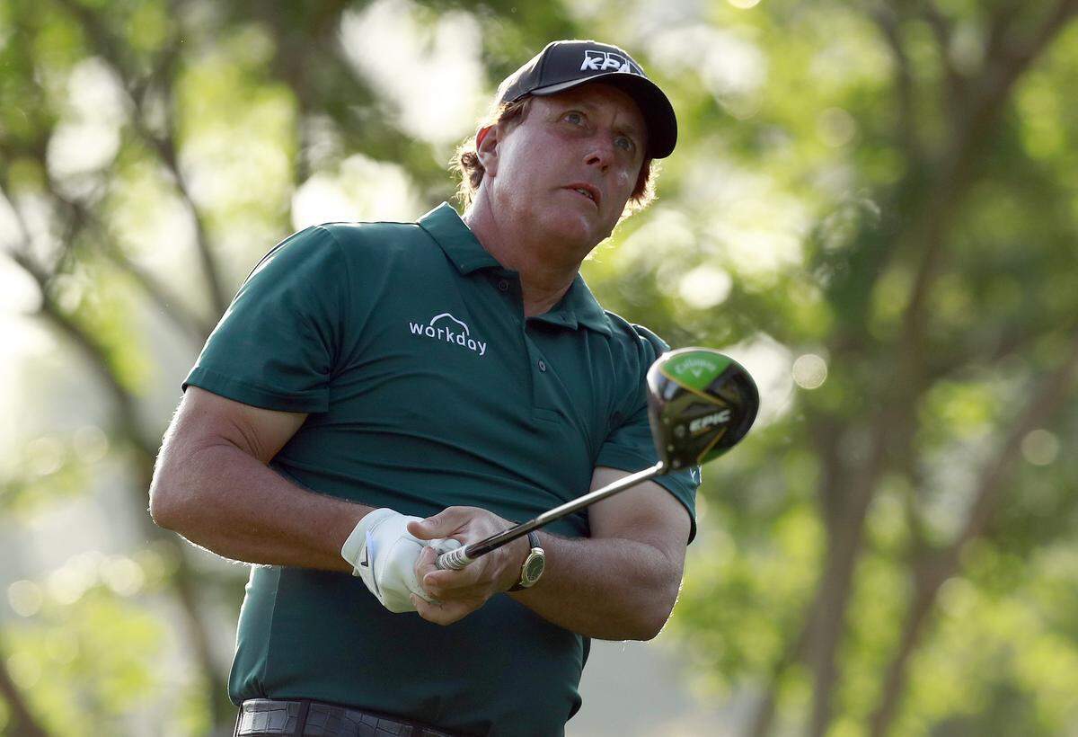 Phil Mickelson watches a tee shot Thursday at the Wells Fargo Championship at Quail Hollow Club. Mickelson wore a shirt Thursday that was similar to the Charlotte 49ers’ primary school color.