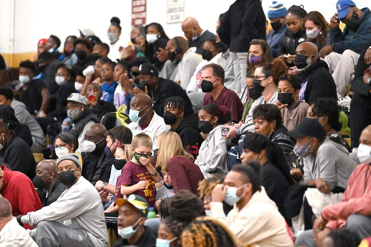 Masks will likely stay around for a while as COVID infections spike in Mecklenburg, experts say.
