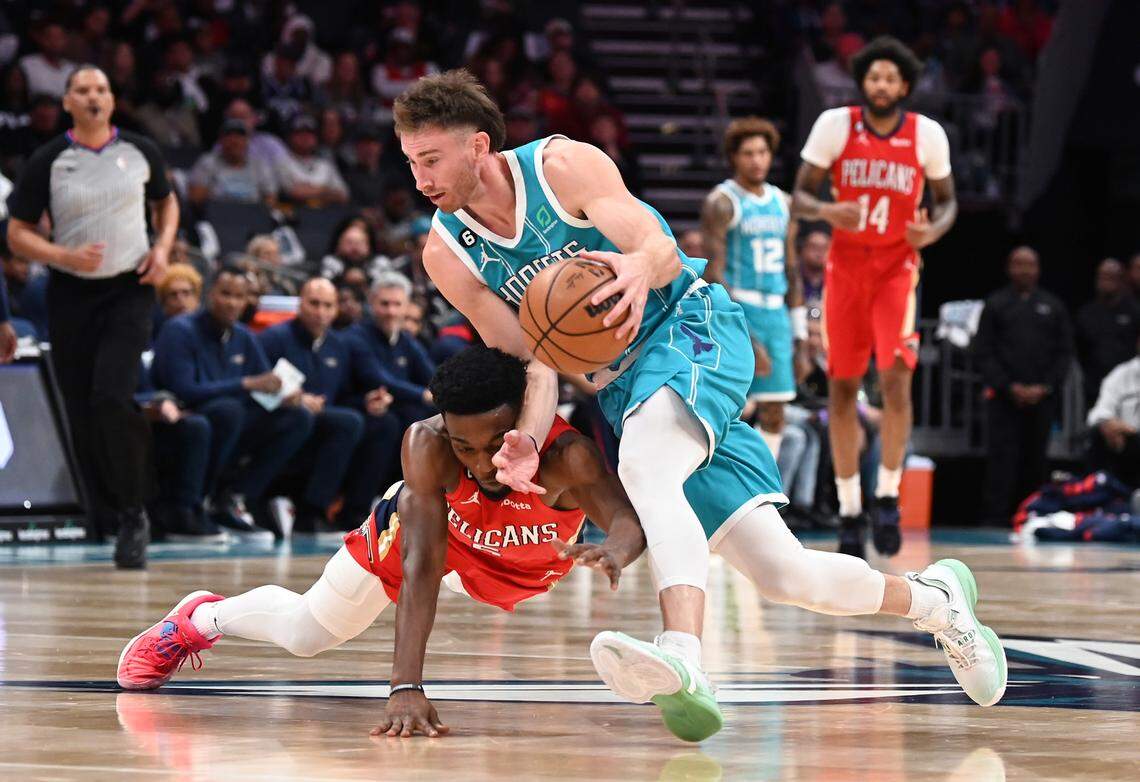 Charlotte Hornets forward Gordon Hayward, right, chases down a loose ball as New Orleans Pelicans guard/forward Herbert Jones, left, dives in an effort to knock the ball away during first half action on Friday, October 21, 2022 at Spectrum Center in Charlotte, NC.