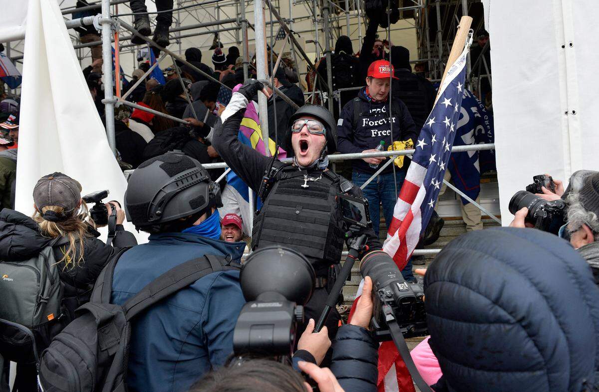 Bank of America, the second-largest bank in the country, is accused of searching its customer base for people who traveled to the Washington, D.C., area around Jan. 6, 2021, according to a lawsuit filed Jan. 5, 2026, in U.S. District Court Middle District of Florida. Shown, a man calls on people to raid the building as Trump supporters clash with police and security forces as they try to storm the US Capitol in Washington, D.C.