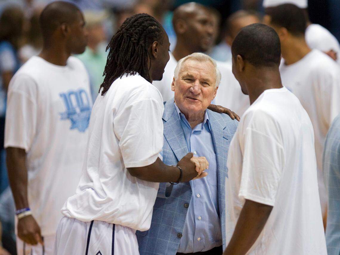 Jeff McInnis hugs Dean Smith prior to the Alumni Game on Friday September 4, 2009 in the Smith Center.