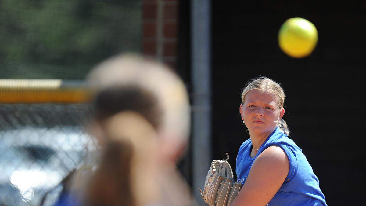 Mooresville Senior High School senior pitcher Campbell Schaen, right, warms up with a teammate during practice Thursday, April 18, 2024, in Mooresville, N.C. (Credit Bill Kiser/Special to the Charlotte Observer)