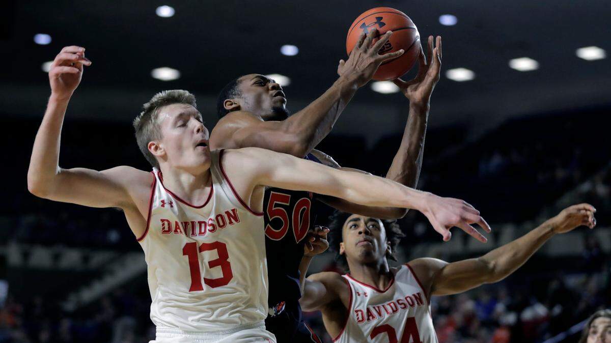 Auburn center Austin Wiley (50) goes up to collect an offensive rebound against Davidson guard Mike Jones (13) and guard Carter Collins (24) on Friday.