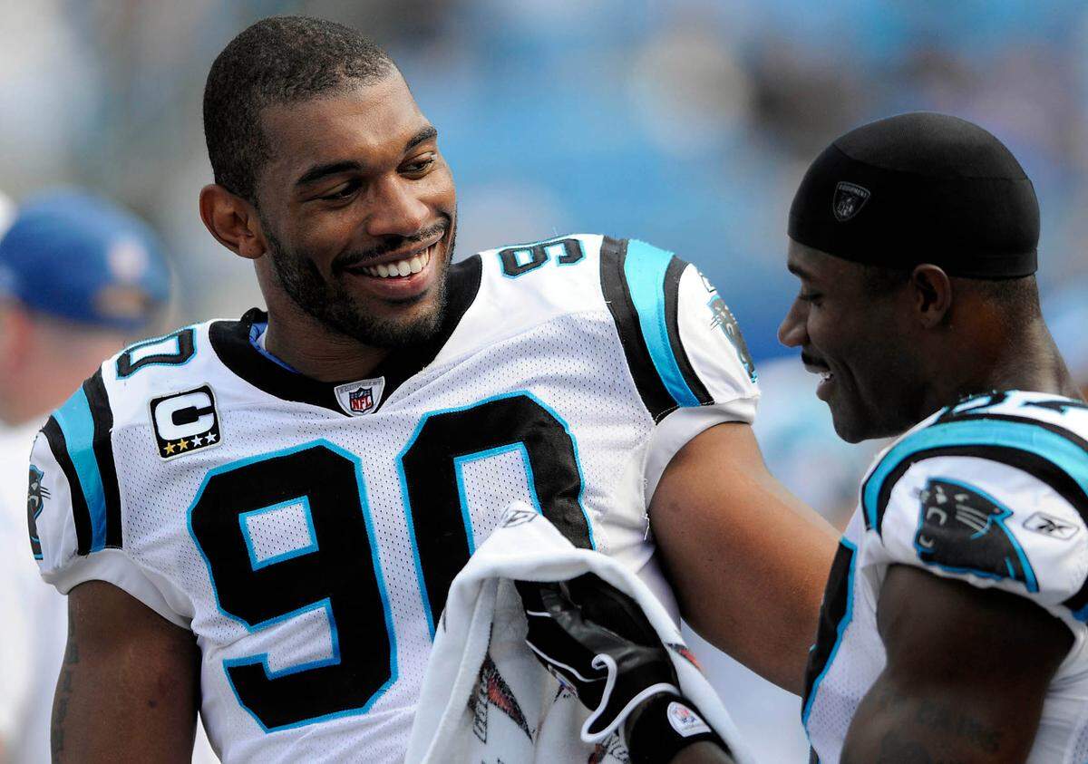 Carolina Panthers’ Julius Peppers (90) and Muhsin Muhammad laugh as they talk on the sideline in the 4th quarter against Kansas City Chiefs at Bank of America Stadium in 2008. The two were announced as the newest inductees into the Panthers’ Hall of Honor on July 10, 2023.