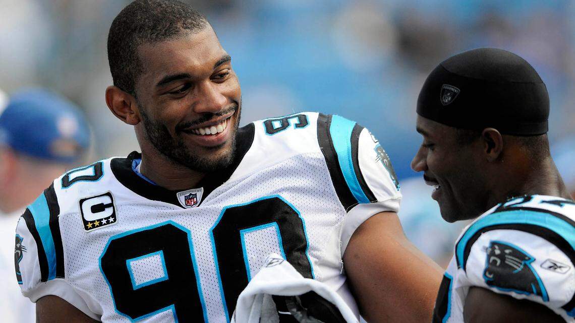 Carolina Panthers’ Julius Peppers (90) and Muhsin Muhammad laugh as they talk on the sideline in the 4th quarter against Kansas City Chiefs at Bank of America Stadium in 2008. The two were announced as the newest inductees into the Panthers’ Hall of Honor on July 10, 2023.