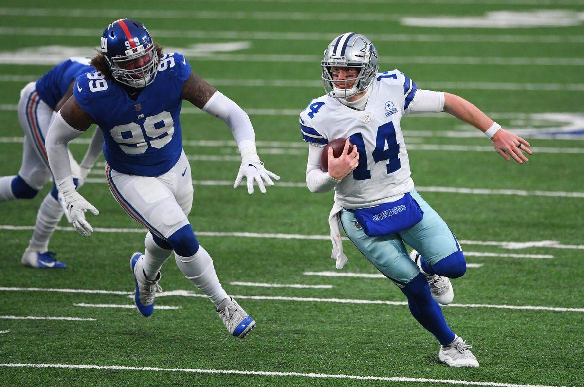 Jan 3, 2021; East Rutherford, NJ, USA; Dallas Cowboys quarterback Andy Dalton (14) runs from New York Giants defensive end Leonard Williams (99) in the second half at MetLife Stadium. Mandatory Credit: Robert Deutsch-USA TODAY Sports