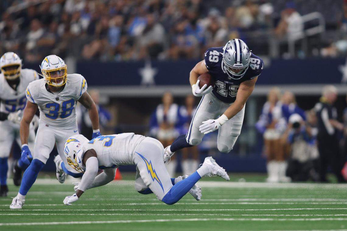 Aug 24, 2024; Arlington, Texas, USA; Dallas Cowboys tight end Alec Holler (49) is tackled by Los Angeles Chargers safety Thomas Harper (37) in the fourth quarter at AT&T Stadium. Mandatory Credit: Tim Heitman-USA TODAY Sports