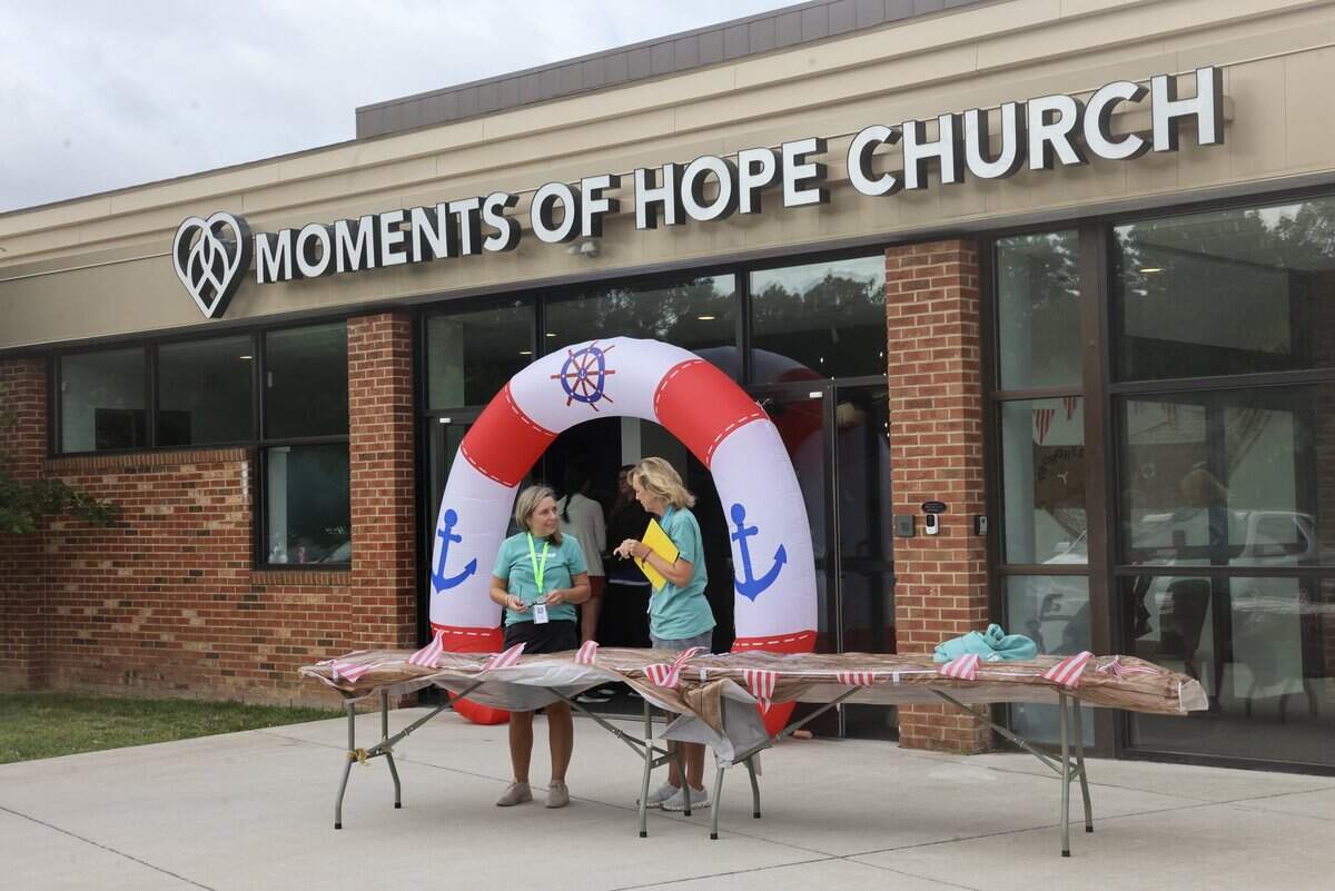Members of Moments of Hope Church work outside the church’s temporary space on International Drive in Charlotte during an event Thursday, June 18, 2026. The church announced Wednesday it has signed an agreement with the YMCA of Greater Charlotte to purchase the Morrison Family YMCA in Ballantyne, about 9 miles away.