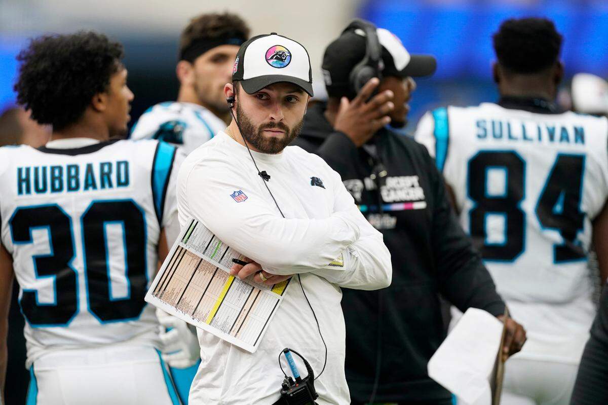 Injured Carolina Panthers quarterback Baker Mayfield watches from the sideline during the second half of an NFL football game against the Los Angeles Rams Sunday, Oct. 16, 2022, in Inglewood, Calif. (AP Photo/Ashley Landis)