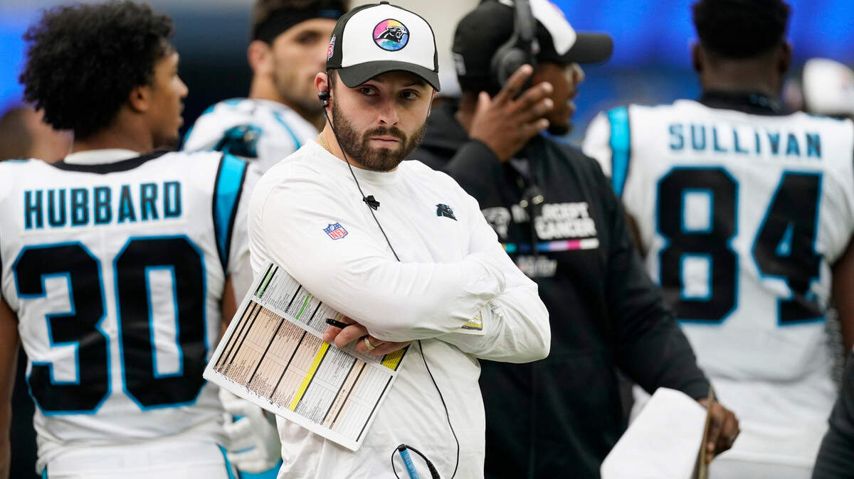Injured Carolina Panthers quarterback Baker Mayfield watches from the sideline during the second half of an NFL football game against the Los Angeles Rams Sunday, Oct. 16, 2022, in Inglewood, Calif. (AP Photo/Ashley Landis)