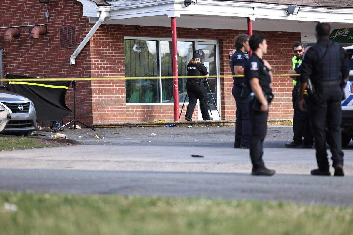 Police work the scene of a shooting at Archdale Minimart & Laundry on Monday afternoon. Initial reports from officials said four people were shot, one fatally.