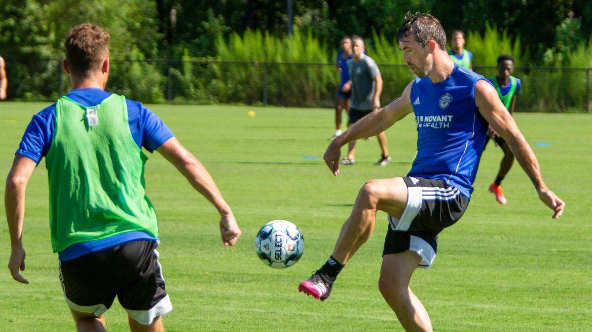 Charlotte Independence defender Christian Fuchs, right, passes the ball during a scrimmage at the Matthews Sportplex in Matthews on Aug. 13. Fuchs will play for Charlotte FC in their inaugural MLS season next year and is currently playing with Charlotte Independence of the USL.