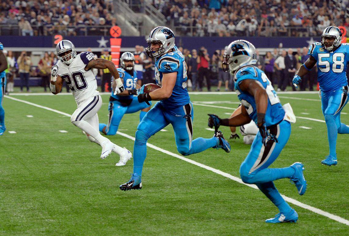 Carolina Panthers linebacker Luke Kuechly (59) takes back an interception for a pick-6 against Dallas and quarterback Tony Romo on Thanksgiving Day 2015. Kuechly had two interceptions in the game and on this play also managed to “get a piece of the quarterback,” too, as he says, much to the joy of his teammates.