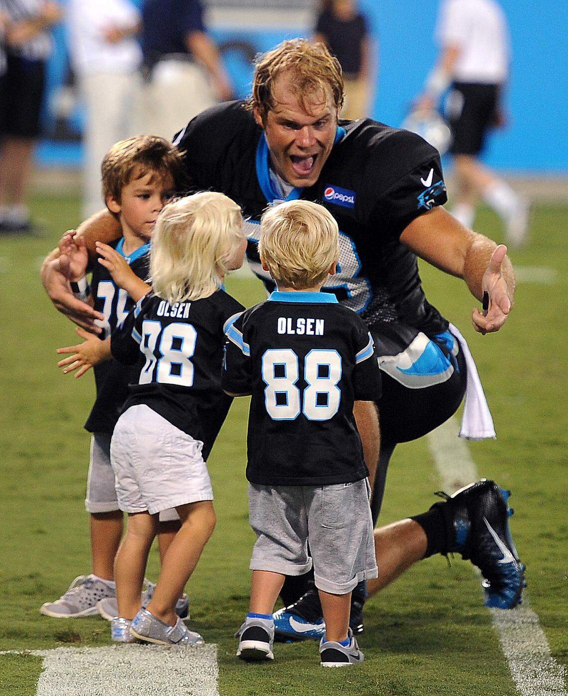 Carolina Panthers tight end Greg Olsen greets his three children -- son Tate, left, and daughter Talbot, center and son T.J. in 2015.